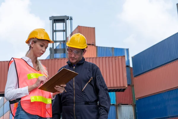 Travailleur industriel travaille avec son collègue à la cour de conteneurs d'expédition outre-mer — Photo