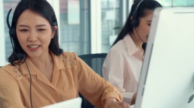 Kulaklık takan iş adamları ofiste aktif olarak çalışıyorlar.