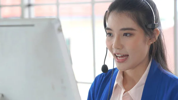 Businesswoman wearing headset working actively in office — Stock Photo, Image