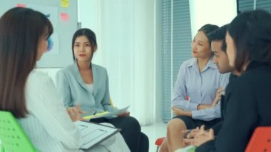İş adamları daire içinde otururken iş projesini ustaca tartışıyor