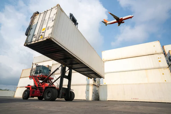 Cargo container for overseas shipping in shipyard with airplane in the sky .