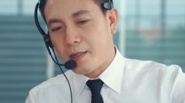 Kulaklık takan iş adamları ofiste aktif olarak çalışıyorlar.