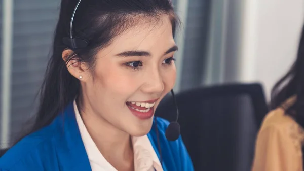 Businesswoman wearing headset working actively in office — Stock Photo, Image