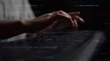 A close-up view of a person hands typing on a laptop keyboard surrounded by floating code snippets in a dark setting, symbolizing programming and technology. Xenic