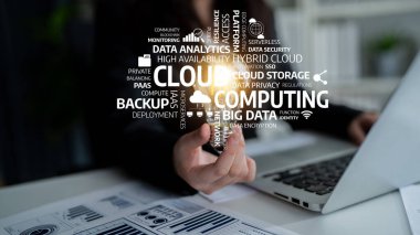 A business professional illustrates the essence of cloud computing through dynamic keywords highlighting data analytics, security, and modern technology in a stylish office. Tessel
