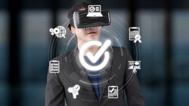 A businessman wearing a virtual reality headset stands in a modern office, surrounded by interactive graphics, representing innovation and digital transformation in business. Raster