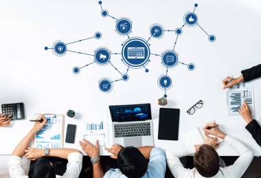 A group of professionals in a modern business meeting discussing digital advertising strategies. Visual elements include charts, data, and technology showcasing insights on performance. Amity