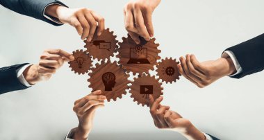 A dynamic composition depicting multiple hands engaging with gears, symbolizing collaboration and innovation in a business setting, driven by technology and communication. Amity