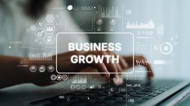 Hands Typing on Laptop with Business Growth Concept and Graph Icons in Modern Office Environment. Asymptotic smart data analytic.