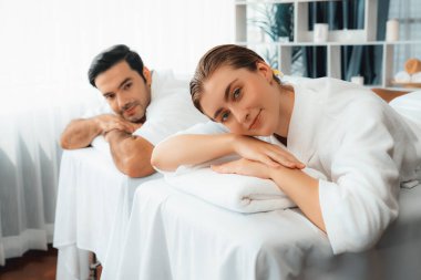 Kafkas çift müşterisi stres önleyici spa masajının keyfini çıkarıyor ve lüks otel veya oteldeki gündüz açık hava ortamında güzellik teniyle eğleniyor. Sessiz.