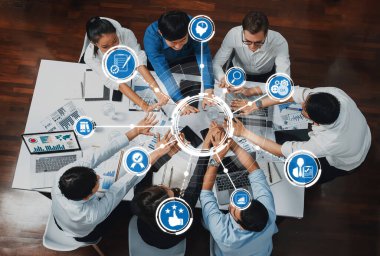 A diverse group of professionals collaboratively working and sharing ideas in a meeting, surrounded by digital icons symbolizing technology and creative processes. Amity
