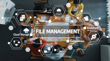 A group of diverse professionals engages in a collaborative meeting focused on effective file management strategies, utilizing cloud storage and innovative tools for enhanced productivity. Amity