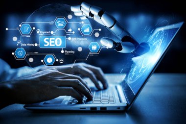 Bir dizüstü bilgisayarın üzerinde çalışan, teknoloji ve dijital pazarlamanın kesişimini sembolize eden SEO kavramlarına odaklanan büyüleyici bir robot el görüntüsü. Tessel