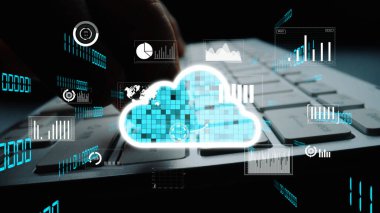 Parlayan bulut sembolleri ve dijital grafiklerle dolu bir klavyenin yakın plan görüntüsü, modern teknoloji ortamında bulut hesaplama ve veri analizi kavramını gösteriyor. Xenic