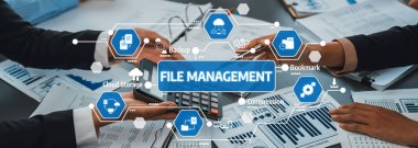 Bu resim, modern ofis ortamında dosya yönetimi uygulamalarını gösteriyor, teknoloji yoluyla işbirliğini ve üretkenliği artırmak için verimli süreçleri vurguluyor. Dostluk