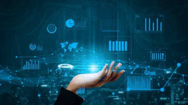 Bir el, yenilik ve bağlantıyı sembolize eden teknolojik bir arkaplan karşısında dijital veri görselleştirmelerine, grafik ve grafiklere doğru uzanır. Xenic