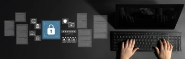 Hands on a keyboard with a computer screen displaying symbols of digital security, illustrating importance of data protection and cybersecurity measures in a connected world. Gantry