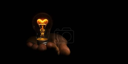 bombilla en forma de corazón incandescente en la mano sobre fondo negro para el día de San Valentín
