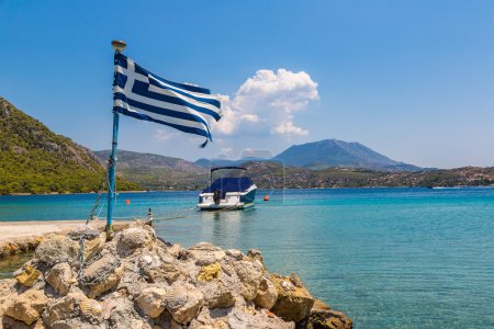 Vouliagmeni lake and greek flag, Greece