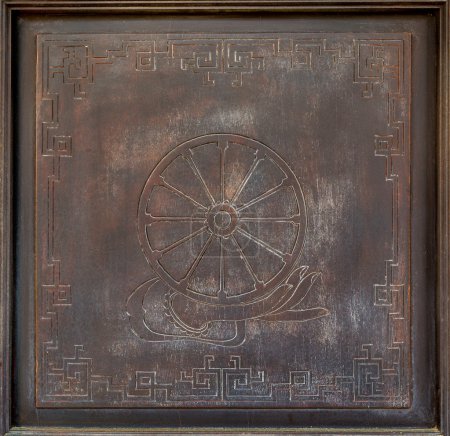 Photo for Dharma Wheel Buddhist symbol in old wood door - Royalty Free Image