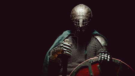 Photo for Medieval knight in the armor with the sword and shield. Artistic toning. - Royalty Free Image