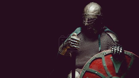 Photo for Medieval knight in the armor with the sword and shield. Artistic toning. - Royalty Free Image