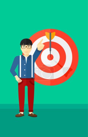 Illustration for An asian man pointing at arrow in a target board on a green background vector flat design illustration. Vertical layout. - Royalty Free Image