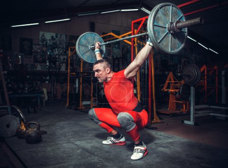 Photo for Powerlifter with strong arms lifting weights - Royalty Free Image