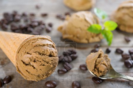 Photo for Close up brown ice cream and coffee beans on old rustic vintage wooden background. - Royalty Free Image