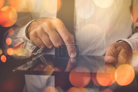 Photo for Businessman working on tablet computer, retro toned image, bokeh light, selective focus - Royalty Free Image