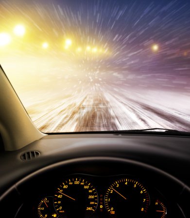 snow-covered road at night