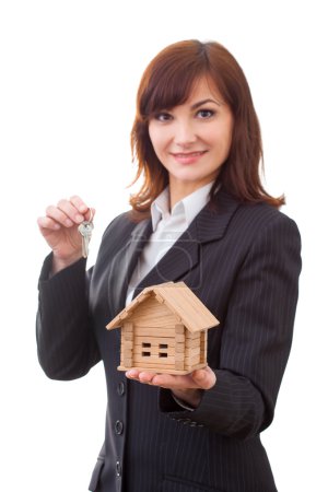 adult realtor with keys and wooden toy house,it could be the tenant too. All isolated on white background.