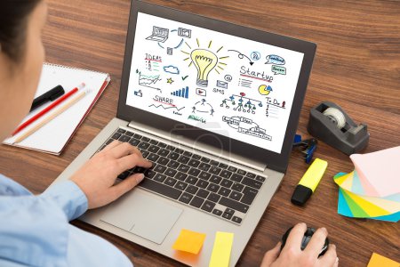 Photo for Close-up Of Businesswoman Looking At Start-up On Laptop - Royalty Free Image