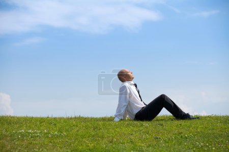 Photo for Young Businessman contemplating in park - Royalty Free Image