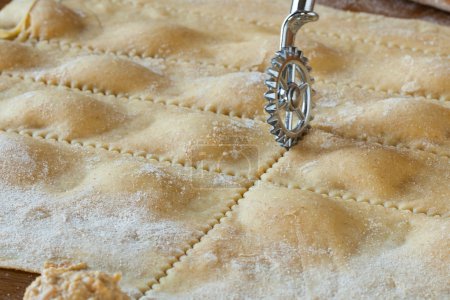 Photo for Homemade agnolotti preparation, cut with the pastry wheel. - Royalty Free Image