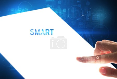 Photo for Hand holdig futuristic tablet with SMART inscription, new technology concept - Royalty Free Image