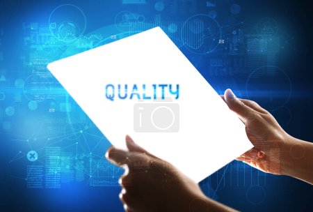 Photo for Hand holdig futuristic tablet with QUALITY inscription, new technology concept - Royalty Free Image