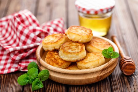 Photo for Curd fritters with honey and mint - Royalty Free Image