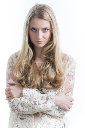 Beautiful Russian blonde girl on a white background in   translucent blouse