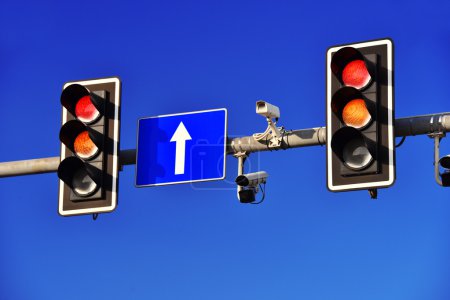 Traffic lights over blue sky