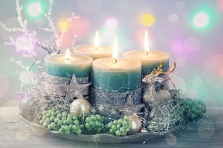 Four green christmas candle