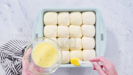 Flat lay. Preparing dinner rolls from the frozen dough in baking pan.