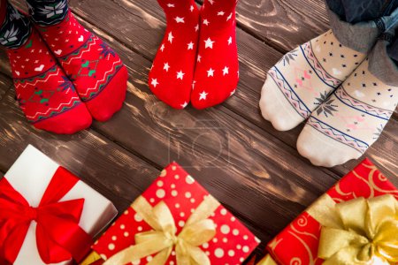 Photo for Feet of family on wood floor. Christmas holidays concept - Royalty Free Image