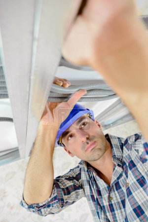 builder installing metal frame at work