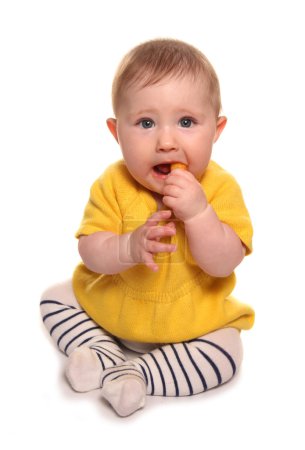 Baby girl eating finger food 