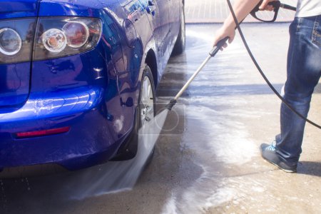 Car wash with flowing water and foam.