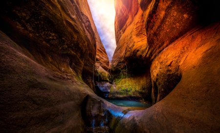 Sun over narrow slot canyon Lake Powell Utah