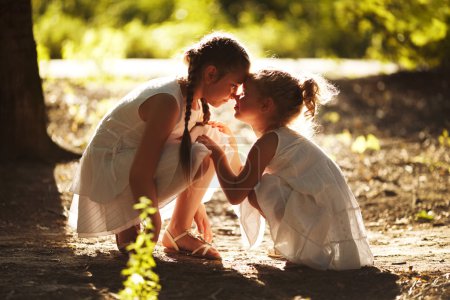 Photo for Happy girl girlfriend sitting in the sun - Royalty Free Image