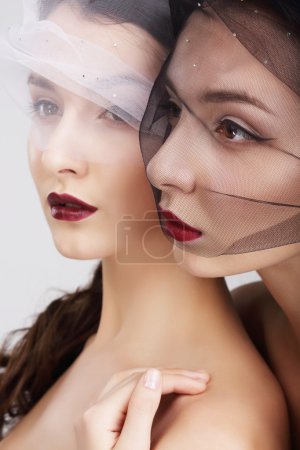 Fondness. Two Females in Veils Embracing