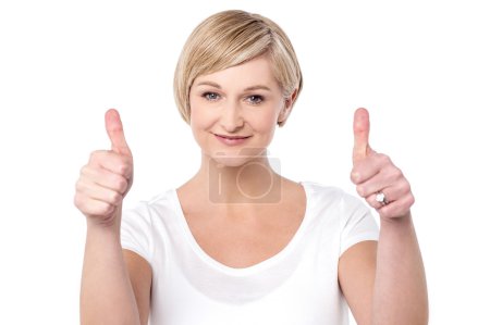 Woman making thumbs up gesture